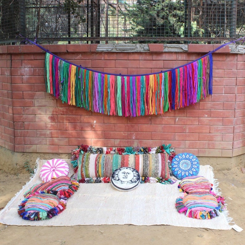 Colorful boho valance and boho style curtains, boho curtains made from upcycled sari fabric with embroidered patchwork pillows in an outdoor rustic setting